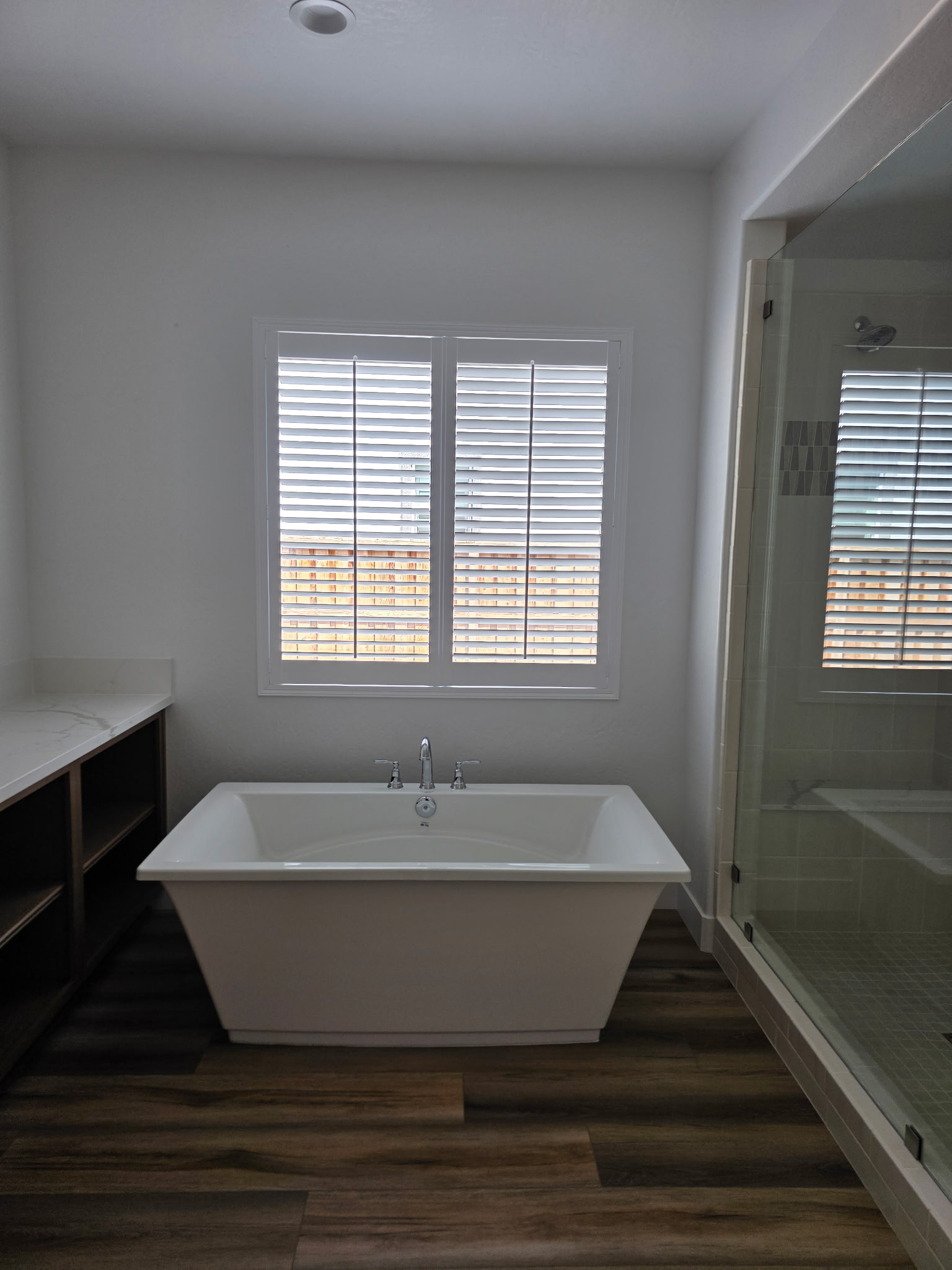 Shutters above freestanding bathtub